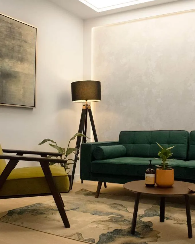 A coaching room with a sofa, armchair and low table.
